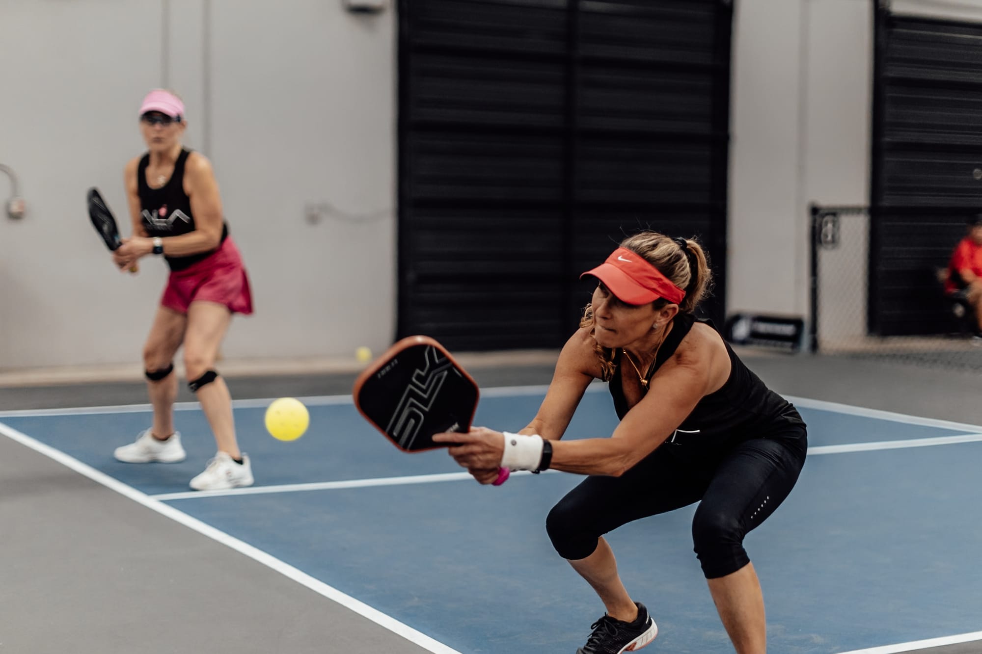Pickleball player hitting the ball